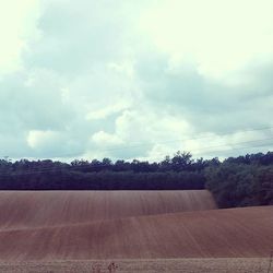 Scenic view of landscape against cloudy sky