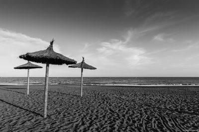 Lifeguard hut on beach against sky