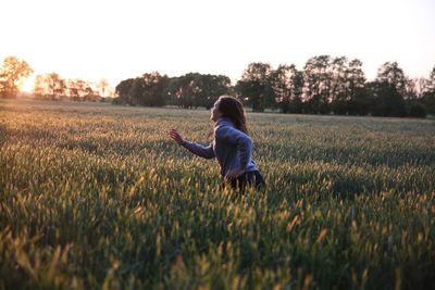 Woman on field at sunset