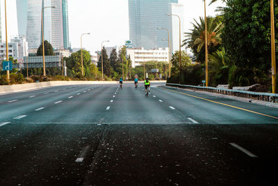 Vehicles on road by buildings in city