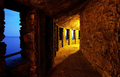 Interior of abandoned colonnade at night