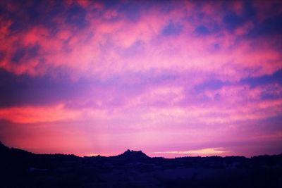 Silhouette of landscape against dramatic sky