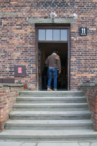 View of man standing at entrance of building