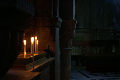 Illuminated candles in temple