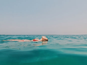 Woman floating in the sea