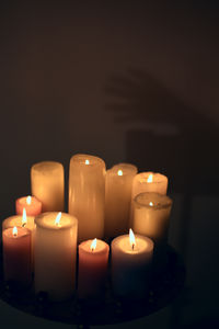 Close-up of illuminated candles against black background