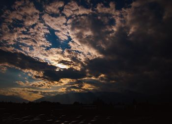 Dramatic sky over silhouette landscape during sunset
