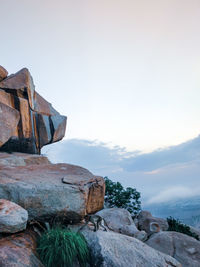 Stack of rocks on land against sky