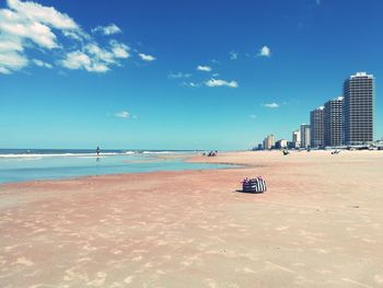 Scenic view of beach against blue sky