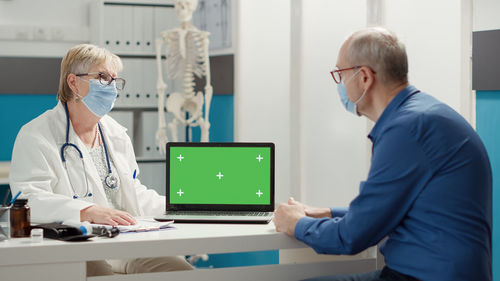 Patient and doctor discussing with each other at clinic