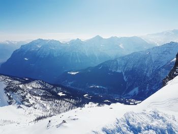 Aerial view of snowcapped mountains against sky