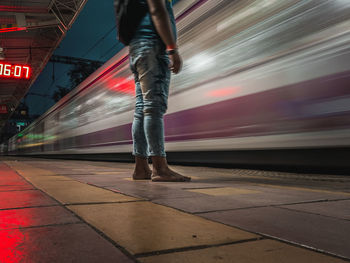 Low section of people standing on railroad station platform