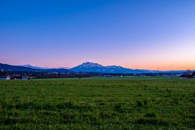 Scenic view of field against sky during sunset