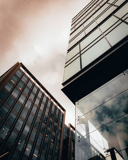 Low angle view of modern glass building against sky