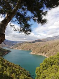 Scenic view of lake and mountains against sky