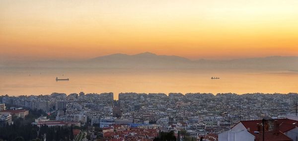 High angle view of buildings against sky during sunset