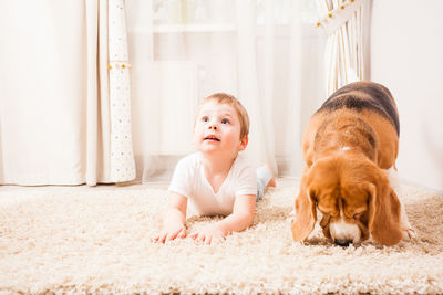 Cute boy with dog at home