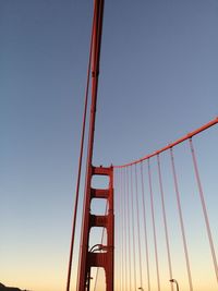 Low angle view of suspension bridge against clear sky