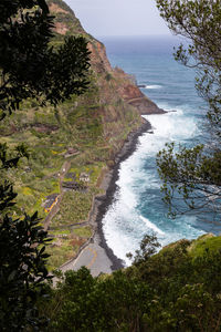 High angle view of sea and trees against sky