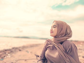 Side view of young woman looking away