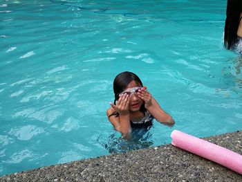 High angle view of boy swimming in pool