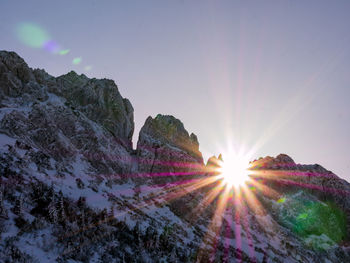 Sunlight streaming through rocks against bright sun