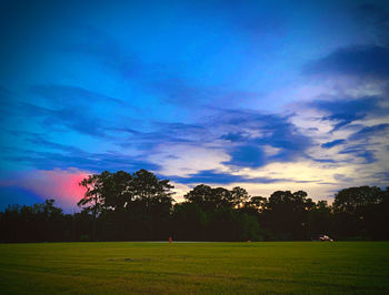 Scenic view of field against sky during sunset