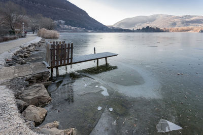 Scenic view of lake against sky during winter