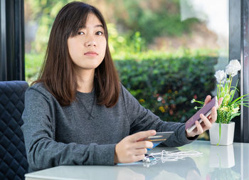 Portrait of young woman using mobile phone