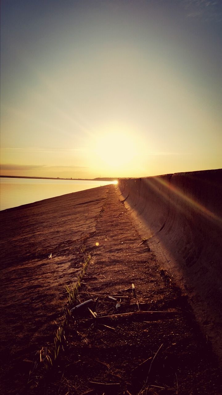 sunset, the way forward, sun, sky, tranquility, tranquil scene, sunlight, scenics, landscape, diminishing perspective, clear sky, nature, beauty in nature, orange color, vanishing point, horizon over land, outdoors, copy space, transportation, surface level