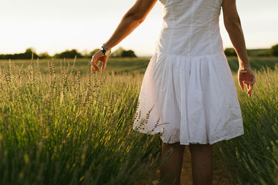 Rear view of woman standing on field