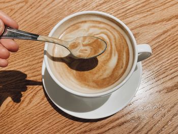 Midsection of coffee cup on table