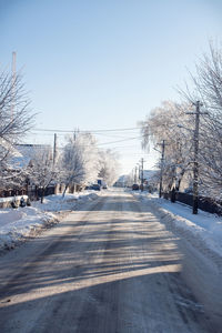 Snow covered road against sky