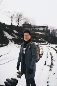 Portrait of man standing in snow