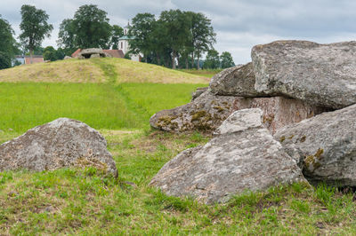 Rocks on field against sky