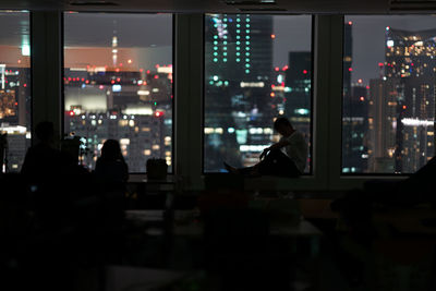 People in illuminated city at night