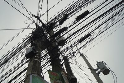 Low angle view of electricity pylon against sky