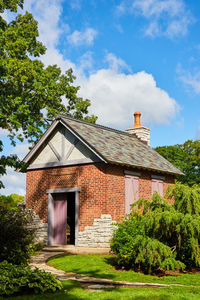 House by trees against sky