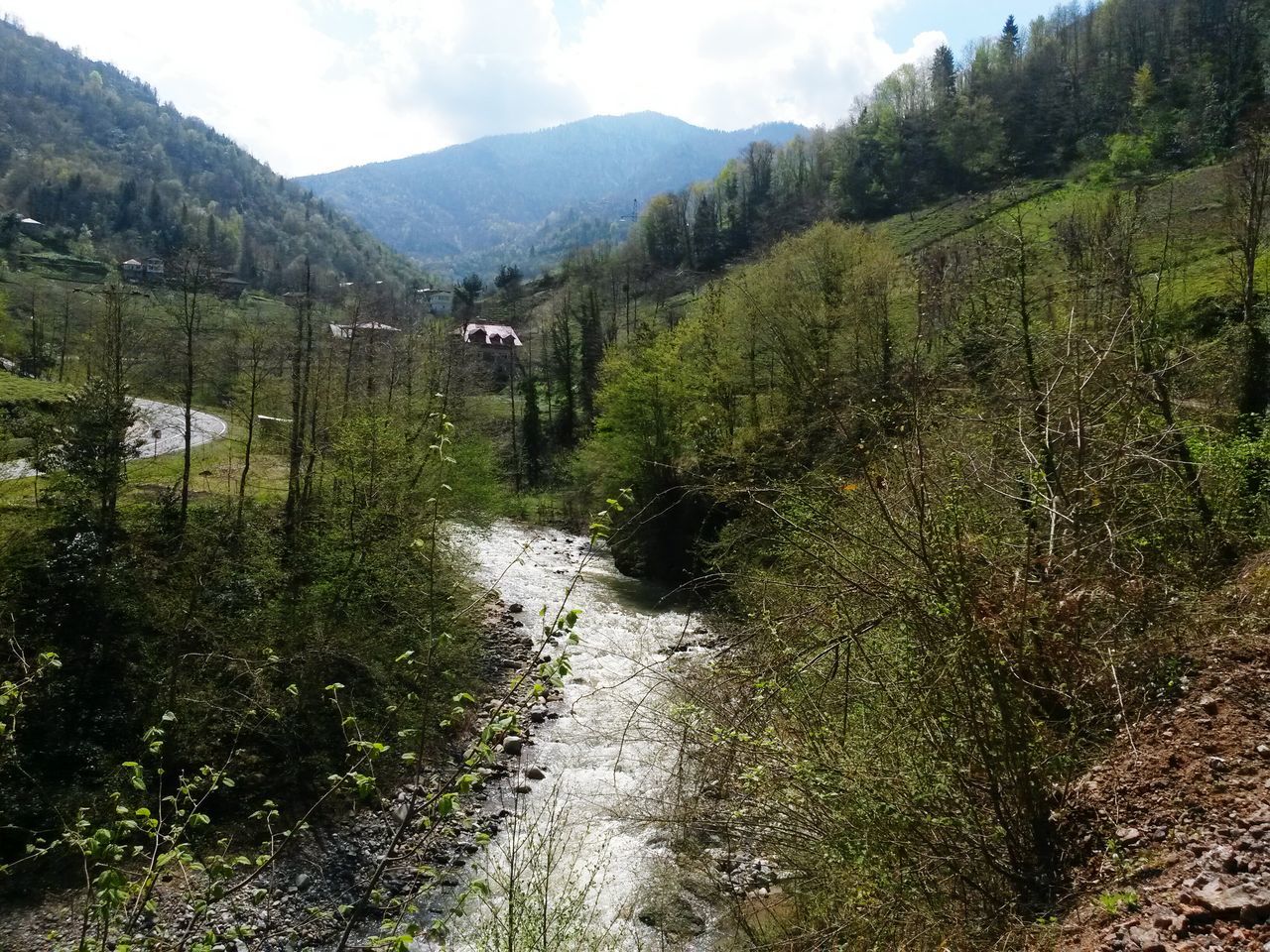 mountain, water, tranquility, tree, tranquil scene, scenics, beauty in nature, nature, green color, mountain range, stream, growth, landscape, sky, river, non-urban scene, grass, plant, idyllic, day