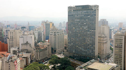 High angle view of buildings in city against sky