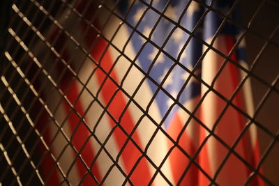 Full frame shot of chainlink fence against american flag