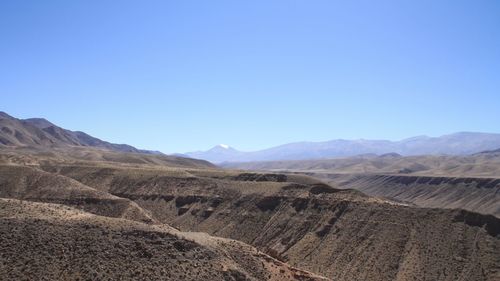 Scenic view of dramatic landscape against clear blue sky