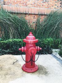 Red fire hydrant on footpath