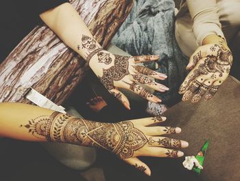 Cropped image of hands showing henna tattoo