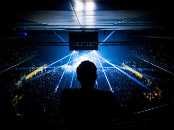 Rear view of silhouette man at music concert