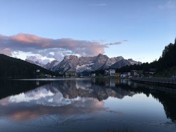 Scenic view of lake by mountains against sky