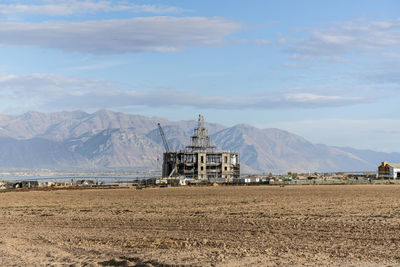 Traditional windmill on mountain against sky