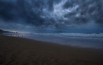 Scenic view of sea against cloudy sky
