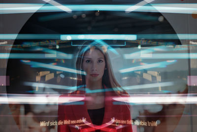 Young woman looking through window