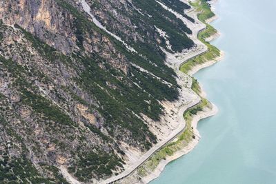 Car tunnel on bank of livigno lake in alps, italy